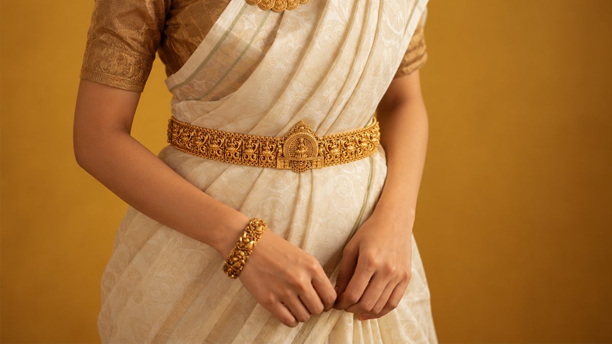 Temple oddiyanam hip belt worn over a silk saree, in gold-plated 925 silver - Vilva Jewels Coimbatore